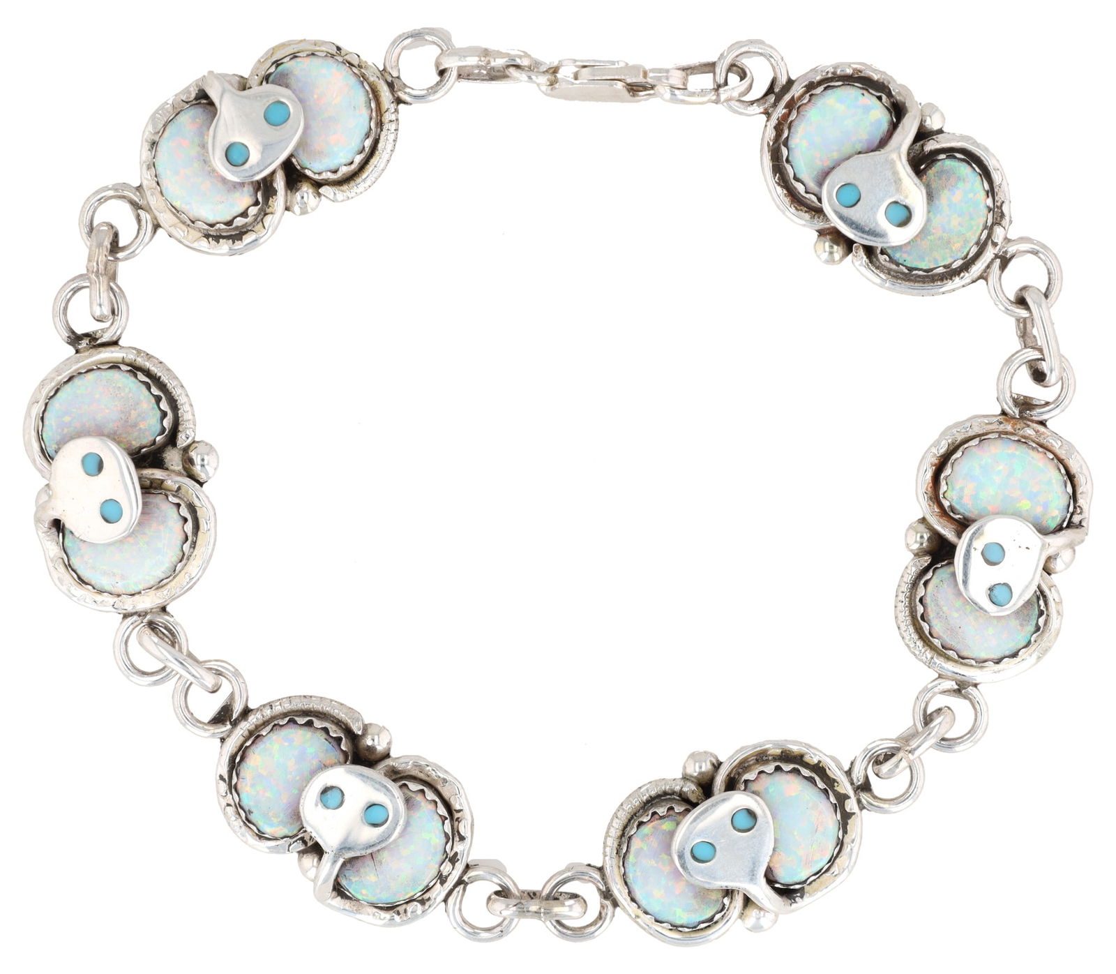 Gayla Calavaza Zuni Silver and Synthetic Opal Inlay Snake Bracelet: Gayla Calavaza Zuni sterling opal snake bracelet. The bracelet comprises seven oval-shaped stations, each featuring an inlay of light-colored, iridescent material, likely synthetic opal, beneath a sty