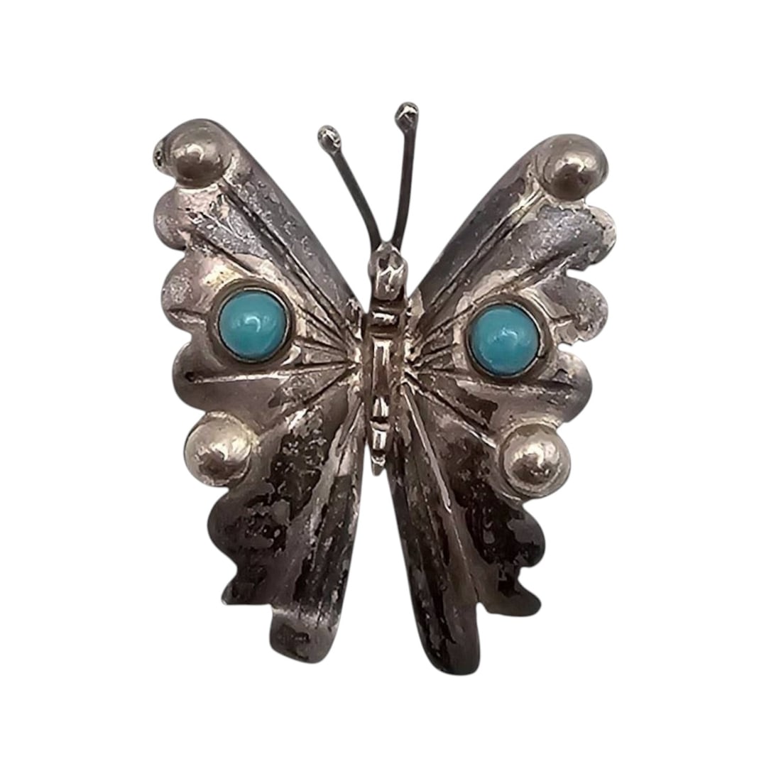 FM Mexico Sterling and Turquoise Butterfly Brooch: FM Mexico sterling silver butterfly brooch featuring two turquoise cabochons as decorative accents. The brooch measures approximately 1 inch in height based on the reference scale and weighs 2.6 grams