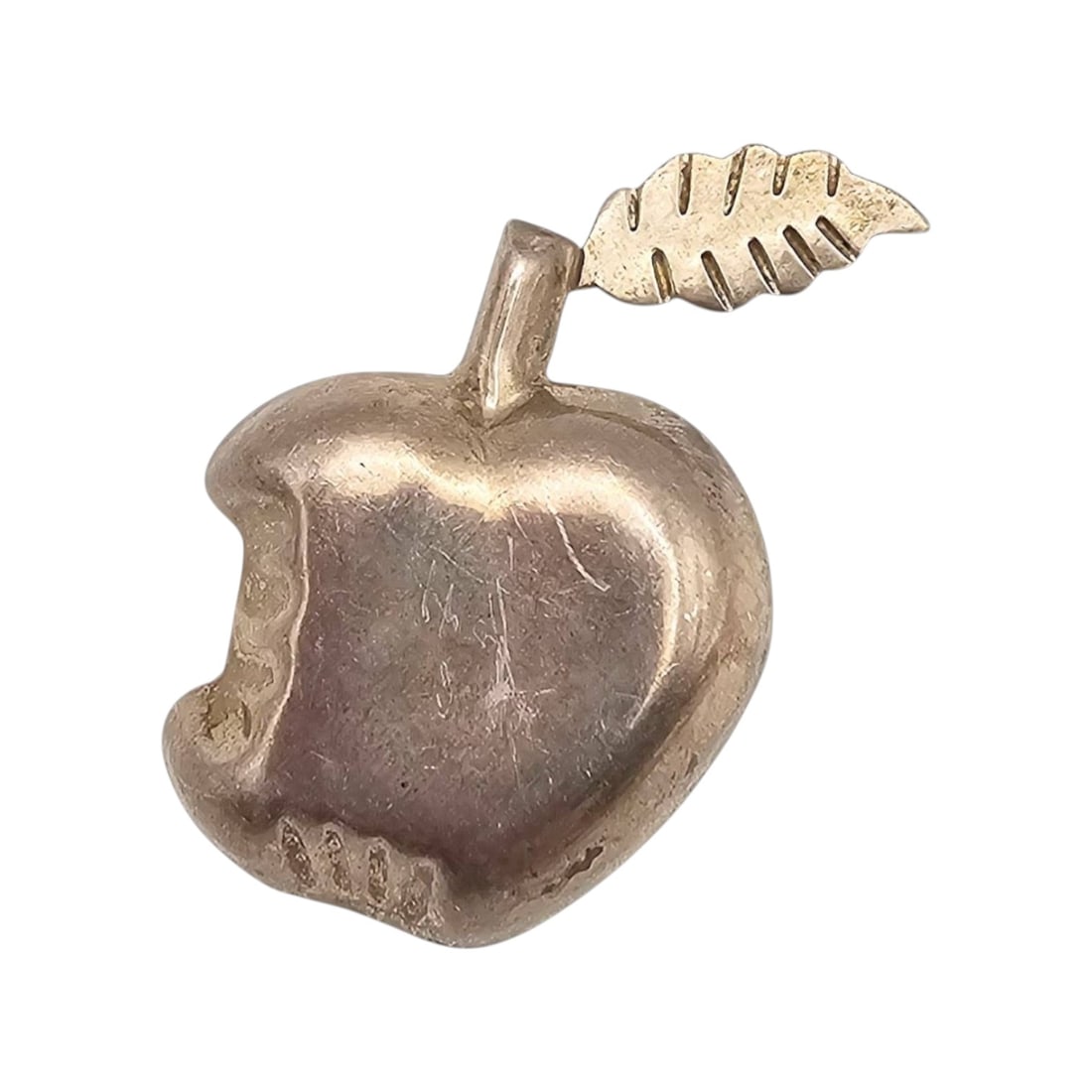 Mexican Sterling TE-20 Apple Pendant: Sterling silver apple-shaped pendant 'TE-20' and ' Mexico' on the reverse, signifying its origin and silver content. The pendant weighs approximately 8.85 grams and features a bitten apple design with