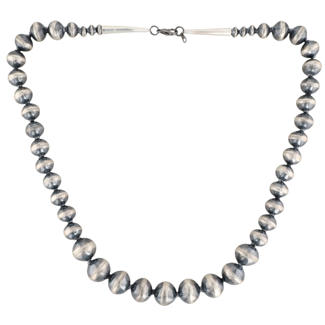 Treva Jim Navajo Sterling Bead Necklace: A Treva Jim Navajo sterling graduated bead necklace, weighing 46g, with 'STERLING' inscribed on its cones, beads graduating from approximately 6mm to 15mm, and an approx. length of 19 inches.