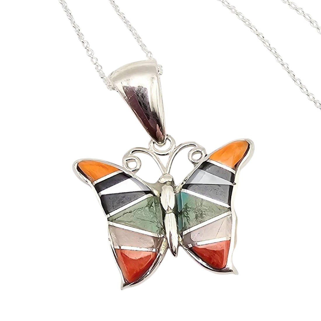 Aldora Henry Navajo Sterling Multi-Stone Butterfly Necklace: Sterling silver butterfly necklace handmade by Navajo artisan Aldora Henry. The pendant features an inlay design with multiple stones, including orange, black, green, and other hues. The reverse side 
