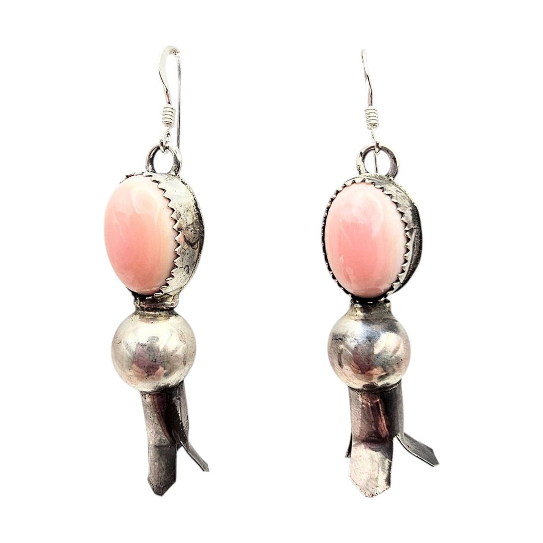 Navajo Sterling Pink Conch Earrings by Tia Long: Tia Long handmade Navajo sterling silver earrings featuring pink conch cabochons. Weighing 8.7 g, these earrings showcase classic Navajo craftsmanship with stamped hallmarks. Measuring against the sca