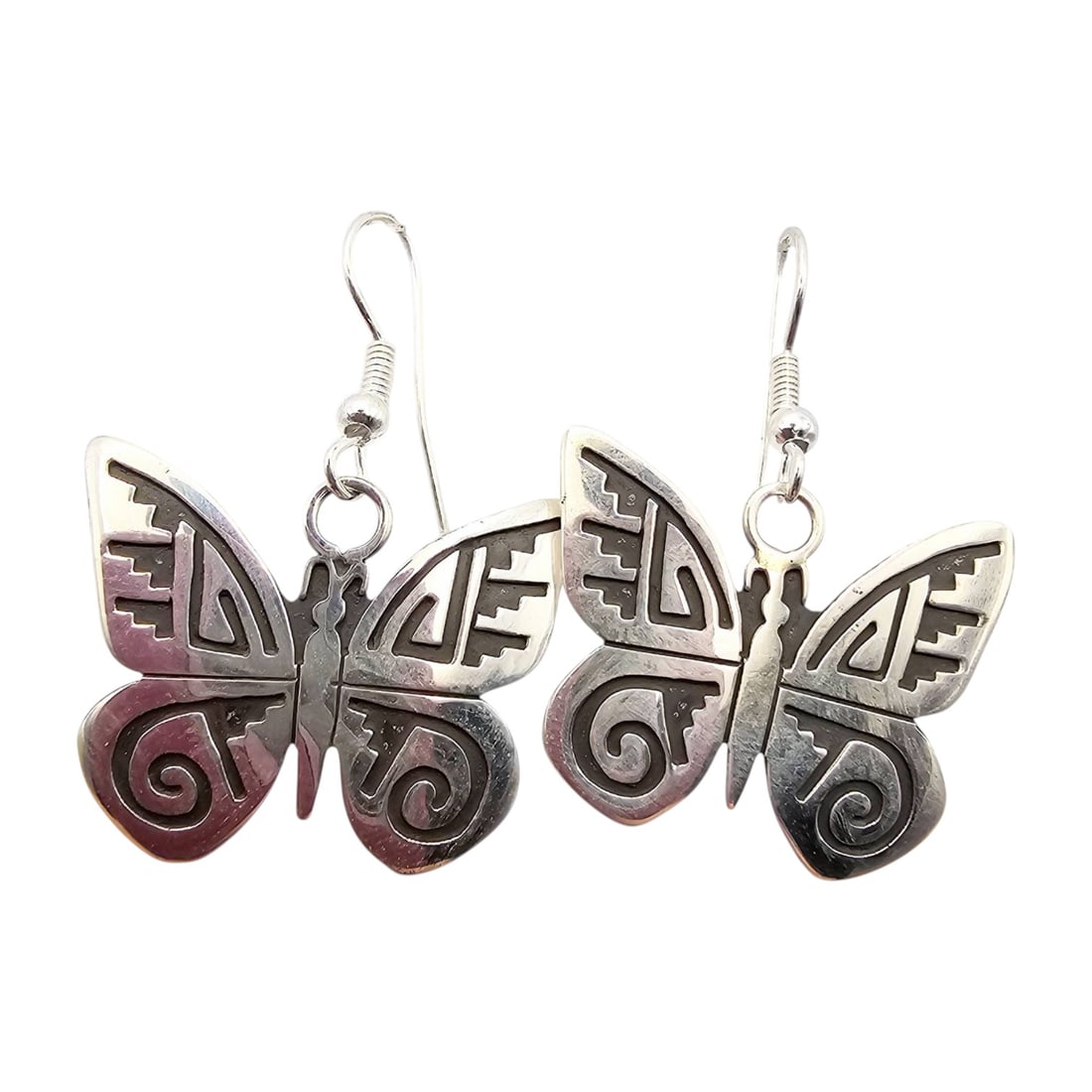 Sonny Gene Navajo Sterling Butterfly Earrings: Handmade sterling silver butterfly earrings by Sonny Gene, a Navajo artisan. The earrings feature intricate tribal-inspired detailing on the butterfly wings, crafted in sterling silver as indicated by
