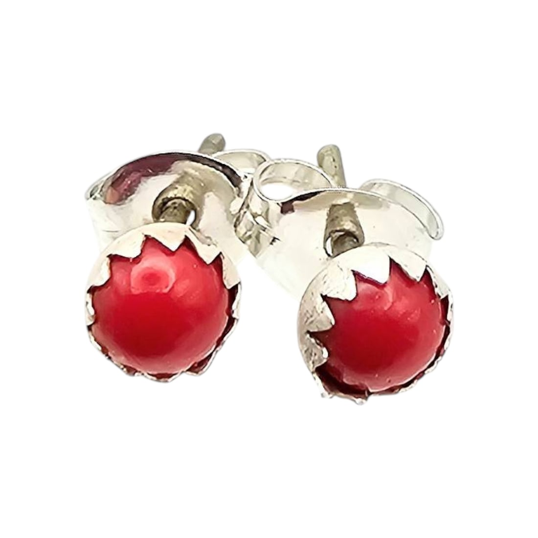 Linda Yazzie Navajo Coral Sterling Earrings: Navajo earrings by Linda Yazzie, featuring coral set in sterling silver. These earrings are small in size, as shown by a comparison to a U.S. quarter. The design features silver prongs holding round c