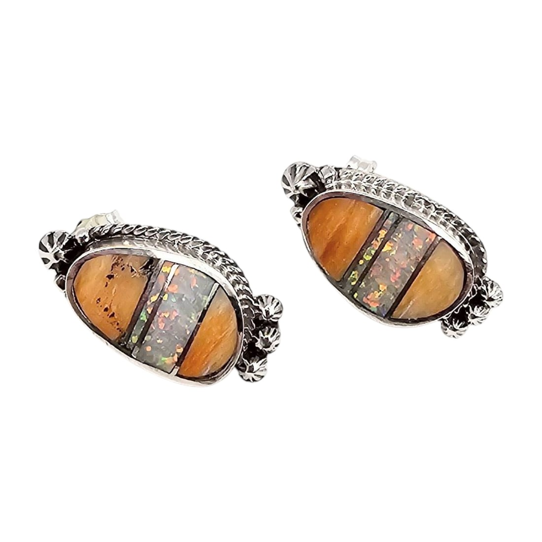 James Manygoats Navajo Spiny Oyster Opal Inlay Sterling Earrings: Handmade Navajo earrings by James Manygoats, featuring spiny oyster and opal inlay in sterling silver. The earrings are intricately crafted with decorative outer borders and measure approximately 7.2