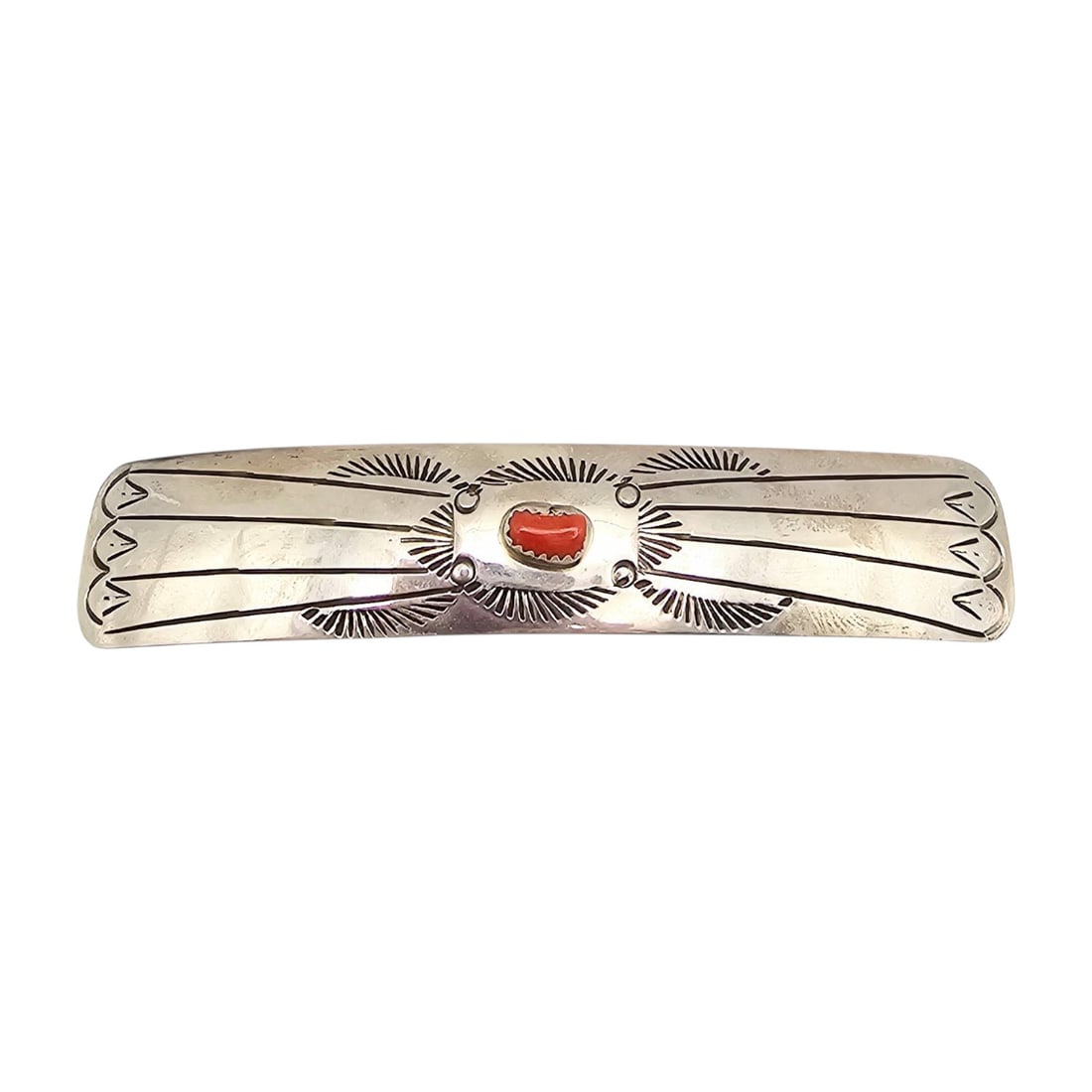 Joanne Navajo Sterling Hair Barrette with Red Coral: A handmade Navajo hair barrette by Joanne, crafted from sterling silver and featuring a red coral centerpiece. The barrette showcases intricate stamped designs typical of Navajo artistry. Measures app