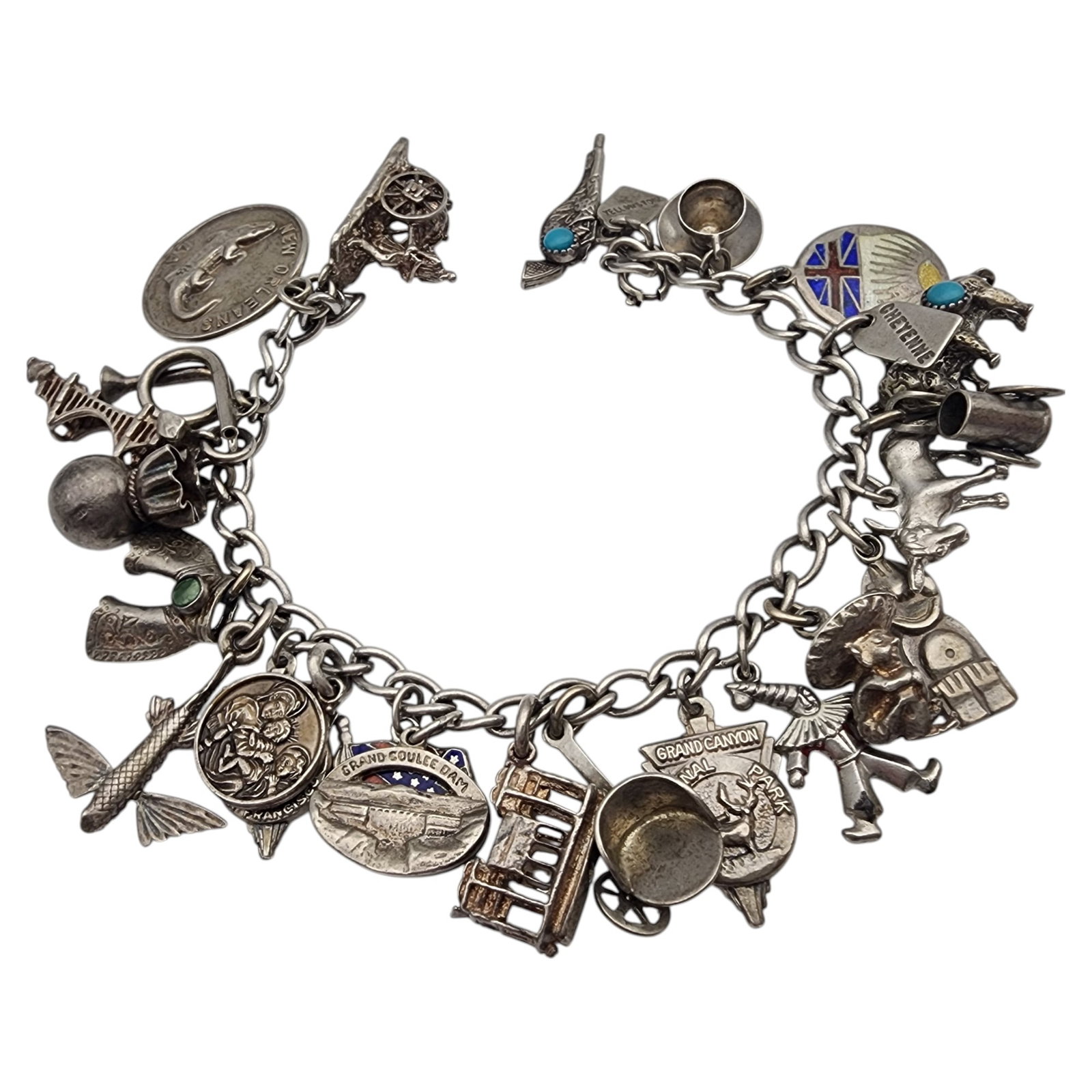 Vintage Sterling Silver Charm Bracelet: Vintage Sterling Silver Charm Bracelet, 53.8g, features a collection of unique charms, including approximately 23 charms with a variety of themes, including turquoise chaps, turquoise pistol, turquois