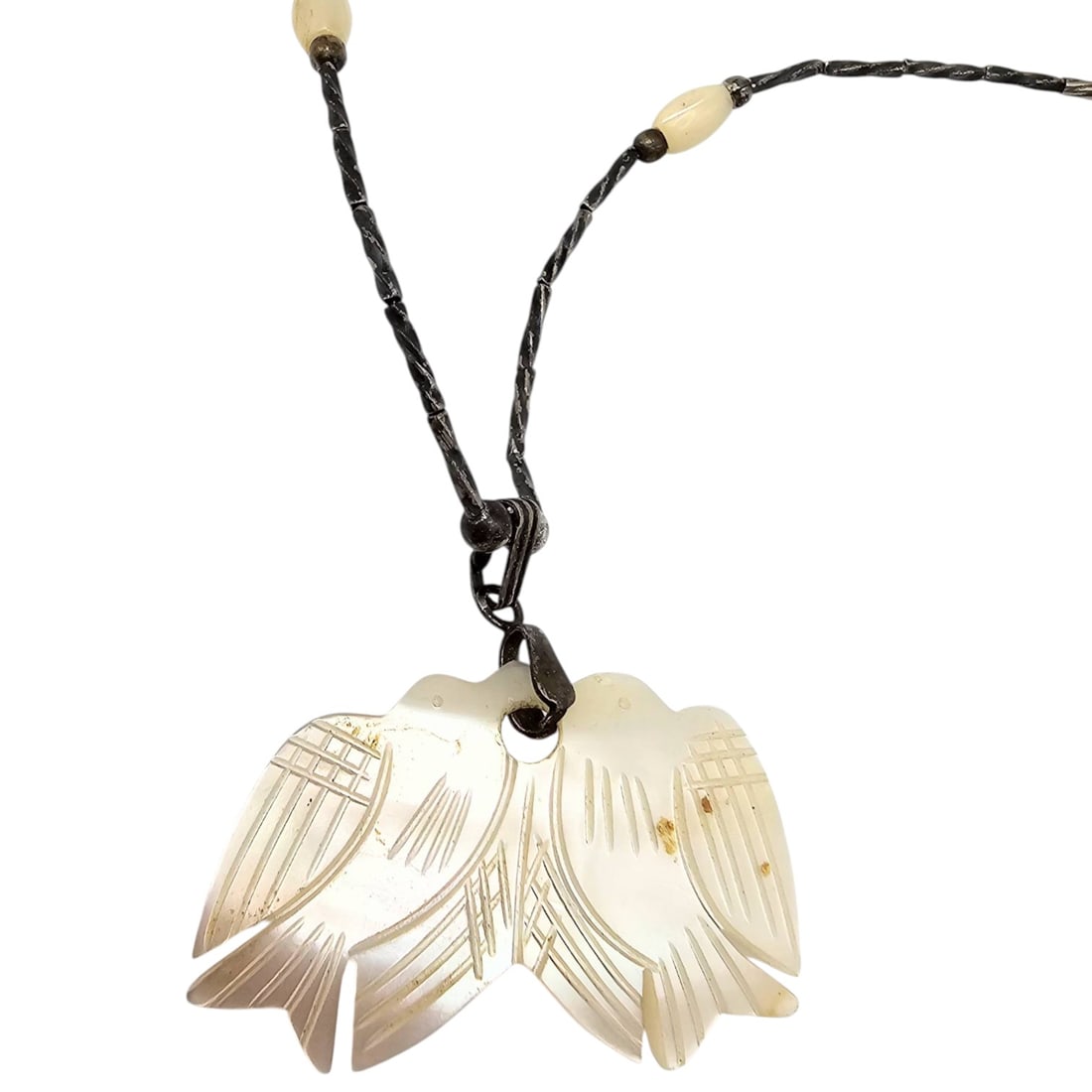 Southwestern Mother-of-Pearl Sterling Liquid Silver Necklace: Southwestern necklace featuring sterling liquid silver components and a mother-of-pearl carved pendant in a wing-like design. Weighs approximately 6 grams. Includes decorative beads and a secure
