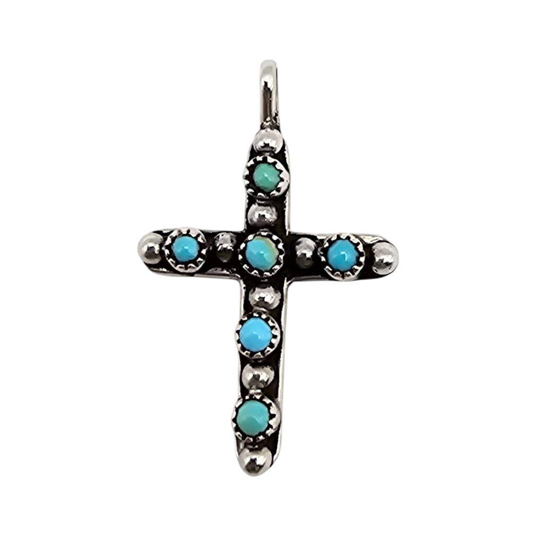 Navajo Sterling Silver Turquoise Snake Eye Cross Pendant: Sterling silver cross pendant featuring turquoise 'snake eye' stones inlaid in a traditional Navajo design. The pendant weighs approximately 2.9 grams and includes intricate silver detailing with a sm