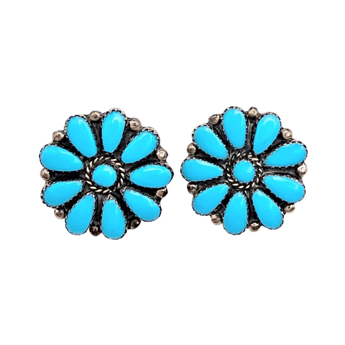 Navajo Sterling Silver Turquoise Flower Earrings: Navajo flower-shaped earrings crafted from sterling silver and adorned with turquoise gemstones. Each earring features a floral design with individual turquoise stones arranged as petals. Weighing 7.4