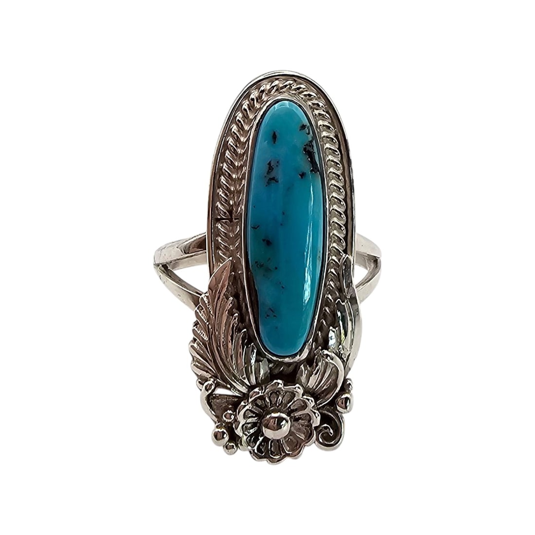Signed Sterling Silver Turquoise Ring Size 7.5: Sterling silver ring featuring an oval turquoise centerpiece with black veining. The design includes floral and leaf motifs, and the ring is signed on the underside. The band size is 7.5, and the ring
