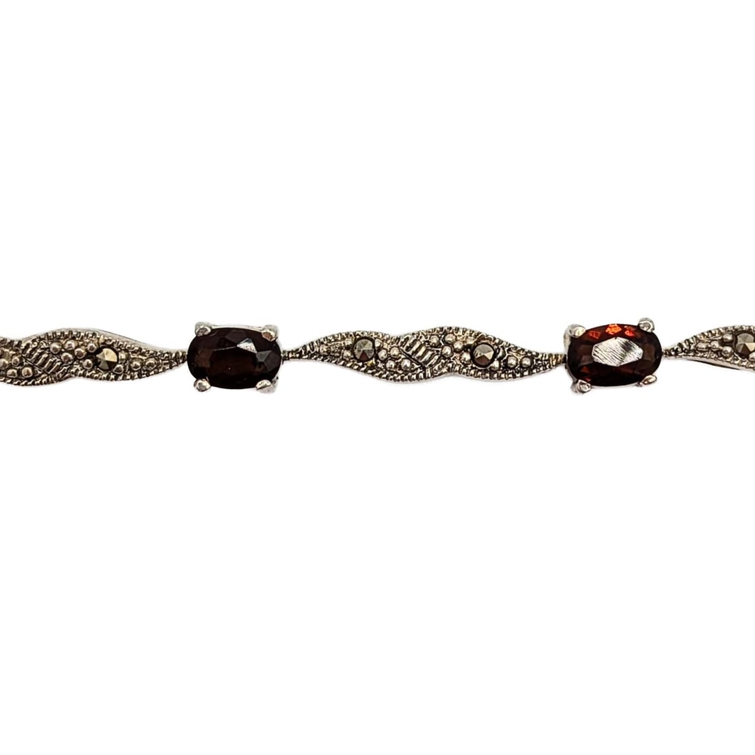 Sterling Silver Garnet Marcasite Tennis Bracelet: Sterling Silver, Garnet, Marcasite Tennis Bracelet. 8.5in Length. Signed 925. 9g