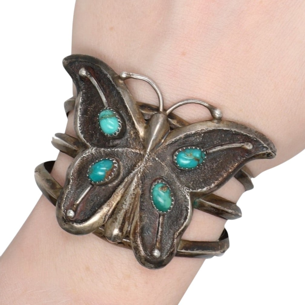 Vintage Signed Navajo Sterling Turquoise Cast Butterfly Cuff Bracelet: Vintage Signed MW Navajo Sterling Turquoise Tufa Cast Butterfly Cuff Bracelet | Weight: 49.7g | Approximate Inner Circumference (Including Gap): 6" | Gap: 1.25" | Butterfly 2.6" x 1.7"