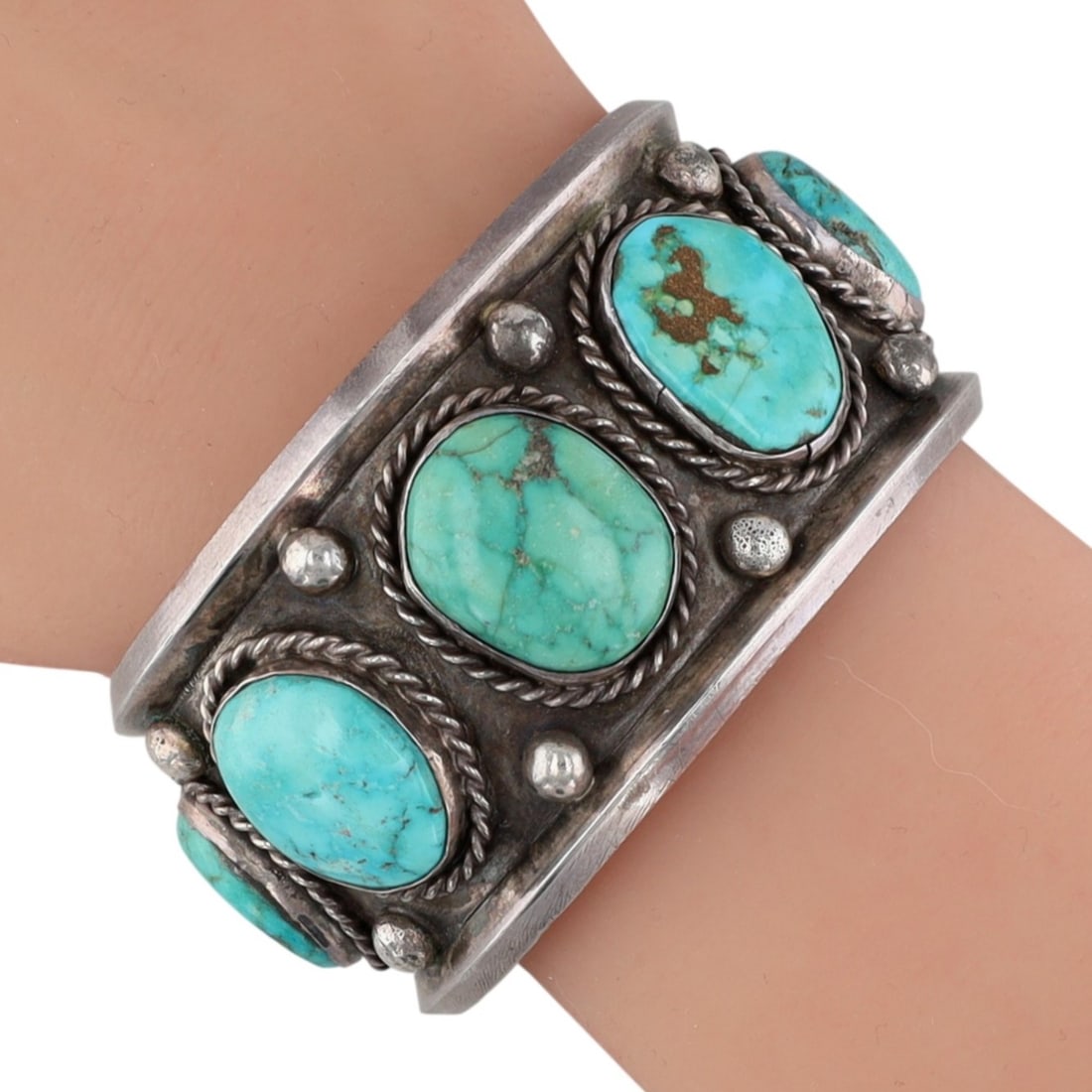 Vintage Navajo Sterling Turquoise Row Cuff Bracelet: Vintage Navajo Sterling Turquoise Row Cuff Bracelet | Weight: 74g | Approximate Inner Circumference (Including Gap): 6.5" | Gap: 1.1" | Width: 1.4" | Provenance: From an estate of a longtime Native Am