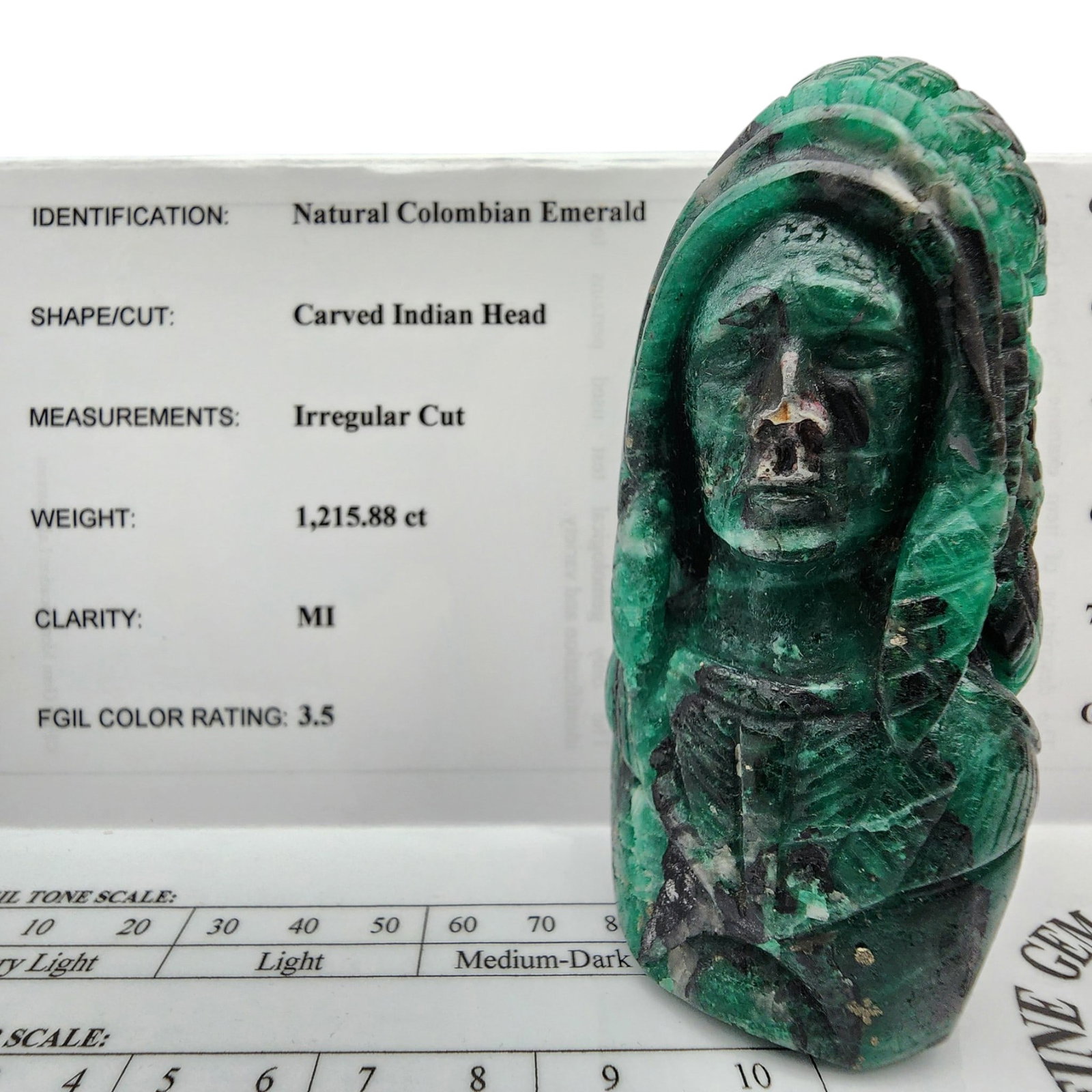 Certified Natural Colombian Emerald Indian Head Carving: Certified Natural Colombian Emerald Indian Head Carving | 4.1" x 1.7" x 1.8" | Gemstone Identification Report completed by Fine Gem Identification Laboratories in 2003. | 1,215.88 carat | Clarity: MI 