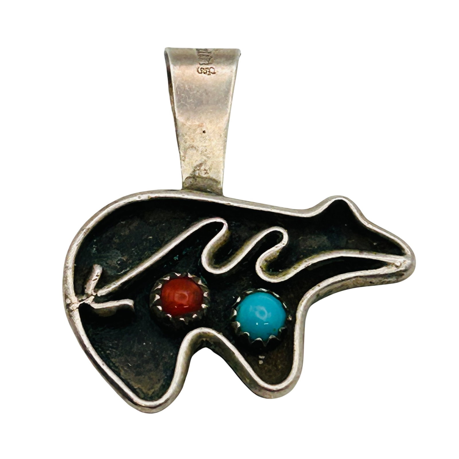Signed Navajo Sterling Reversible Bear And Kokopelli Pendant: Signed CT Navajo sterling reversible bear and kokopelli pendant 4.6g —. Raised kokopelli emblem and garnet reverse side shadow box bear and arrow coral and turquoise. Slight bend in pendant clas