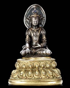 A 17th-century seated Buddha statue: A 17th-century seated Buddha statue, silver inlaid with gold and precious stones, Tibetan Sakyamuni.Provenance: European private Buddha statue collector, 2017 China Poly Spring Auction, Australian