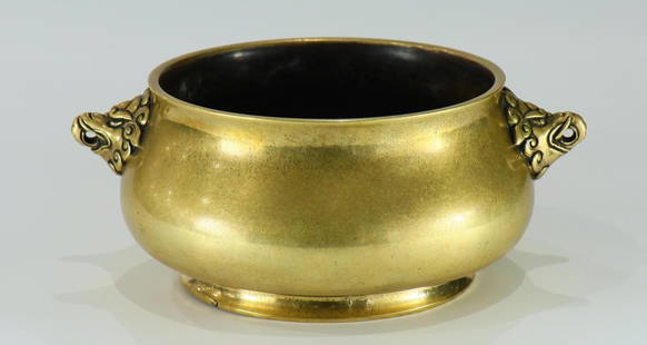 A large size bronze censer: A large size bronze censer from 17th century, decorated with double Capricorn heads and carved six-character year mark on the base. With original wooden seat. Provenance: From the collection of Lawren