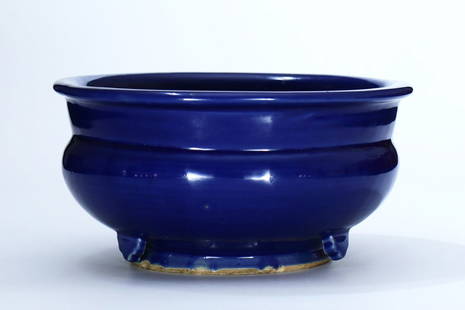 A blue-glazed large porcelain incense burner: A blue-glazed large porcelain incense burner with suspended feet, probably from 14th century Yuan or Ming. No identical or similar objects have been found in previous publications, auction records or
