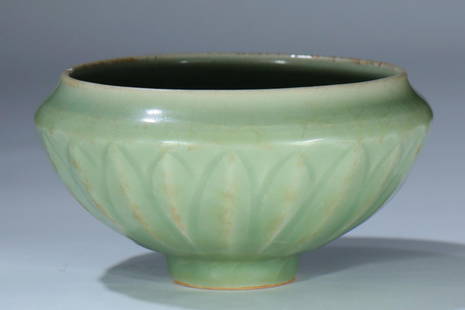 A Long Quan kiln celadon tea bowl: Ming Dynasty 14th century or earlier Long Quan kiln celadon tea bowl, carved with lotus petals on the outside. Provenance: I.K. Gallery AUS, a private collector in Australia.