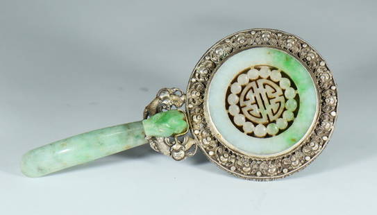 A 19th or early 20th century silver hand mirror: A 19th or early 20th century silver hand mirror with jadeite hook handle and openwork carved jadeite accessory on the back.