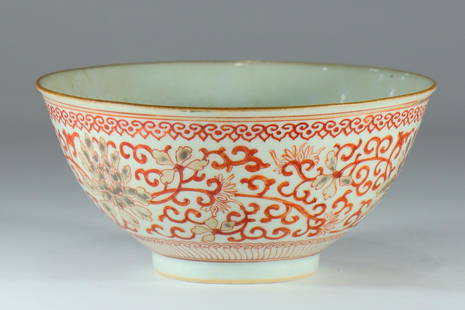 A 19th century famille rose porcelain bowl: An early 19th century famille rose porcelain bowl decorated with floral wrappings and a merchant's mark on the bottom.