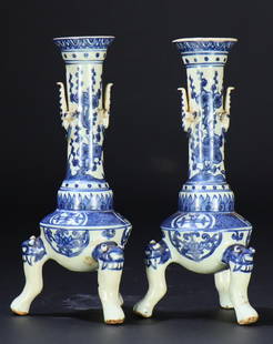 A pair of blue and white porcelain candlesticks: A pair of blue and white porcelain candlesticks decorated with animal feet and ears, Ming Dynasty, 16th century.