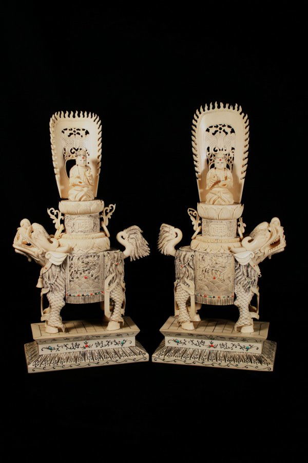 Pair of Intricate Chinese Ivory Figures of Foo Lion: A very intricately carved pair of Chinese Ivory Figures of Attendants riding atop Foo Lions, inset with Gems, 14"H