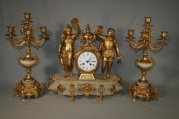19thc French Marble/Gilt Metal Clock Set: A three piece set – clock and garniture. The clock is 17" x 18" and the candelabra are 19"H