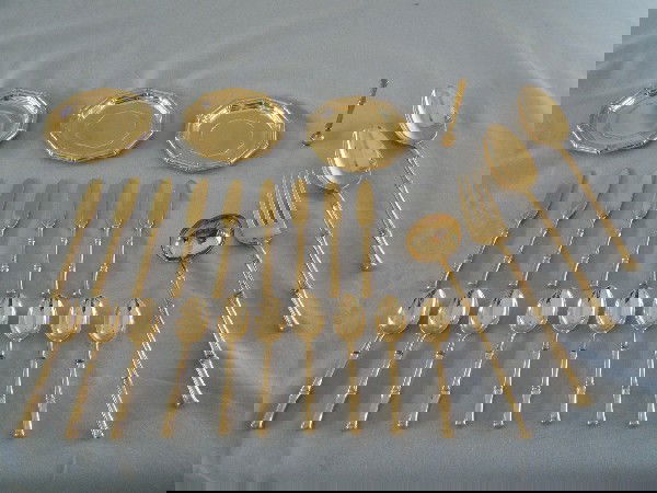 Tiffany Bamboo Sterling Silver Vermeil Flatware: A partial service of 27 pieces comprising of 10 demitasse, 8 butter knives, 1 ladle, 2 serving spoons, 1 serving fork, 4 butter dishes, and 1 telephone dialer. Weighing 40 T.O.