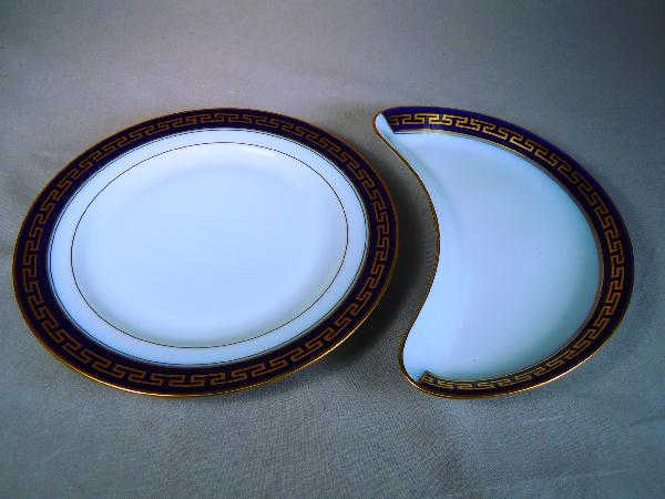 Bernardaud Limoges China, "Peloponese": "Peloponese" pattern china comprising of: 8 luncheon plates and one crescent shaped plate. White luncheon disheswith blue trim and a gold Grecian key.