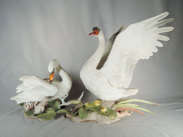 Bohem Porcelain Swan Family Group: One male swan measuring, 19 1/2" tall and one hen with chick measuring, 9 3/4" tall.