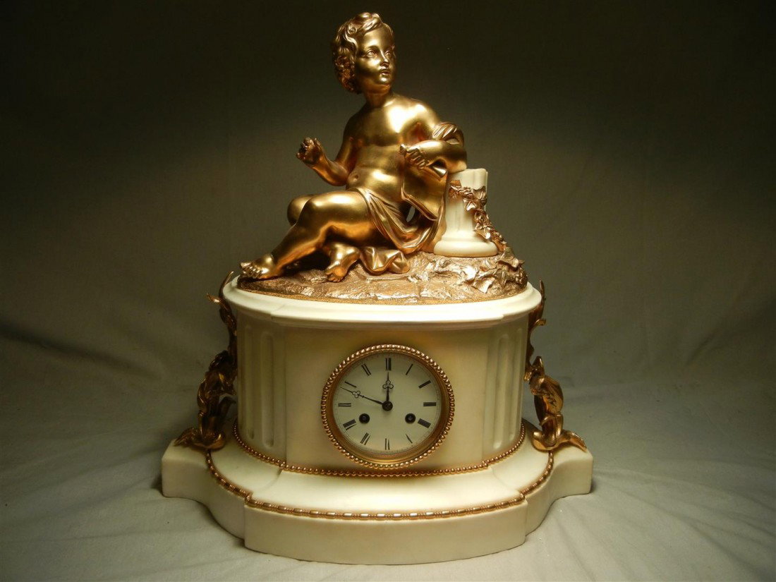 Large 19th Century Dore Bronze & Marble Clock: 19th century French Marble and dore bronze clock with seated putto. Clock measures 20" x 18" x 10."