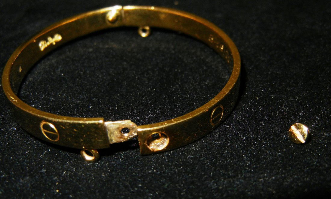 18KYG Cartier "LOVE" bangle bracelet by A. Cipullo: Cartier "Love" bangle bracelet with screw motifs. Bracelet is signed "Cartier, 1970, Aldo Cipullo" and dated "5-16-71." Total gross weight of bracelet is 19.90dwt.