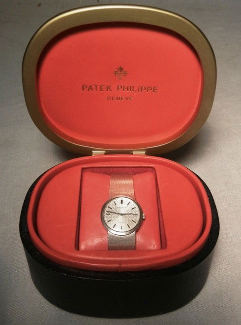 Ladies 18KWG Patek Philippe Watch: A ladies 18k white gold Patek Philippe watch with original box and paperwork. Watch is marked, "Patek Philippe, Geneve 750" (See photos).
