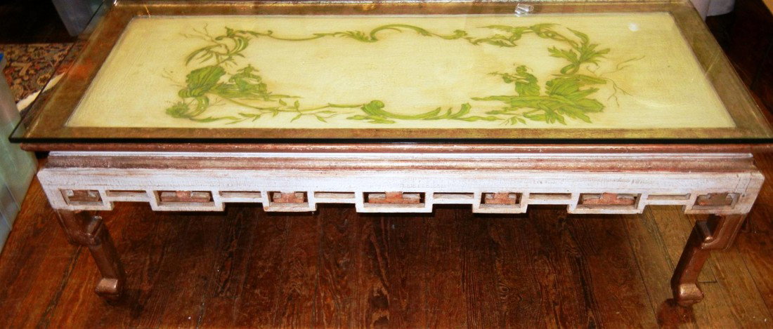 Oriental Painted Ivory & Giltwood Coffee Table: A glass topped painted ivory and giltwood coffee table in the Oriental taste. Table is painted with vignettes of musicians, fretwork apron, on four stylized feet. Table measures 52"l x 22 1/2" x 17 1/