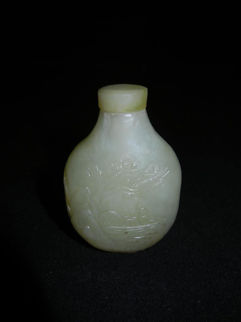 Chinese Carved Celadon Jade Snuff Bottle: A Chinese carved celadon jade snuff bottle measuring 2 1/2" x 1 3/4"