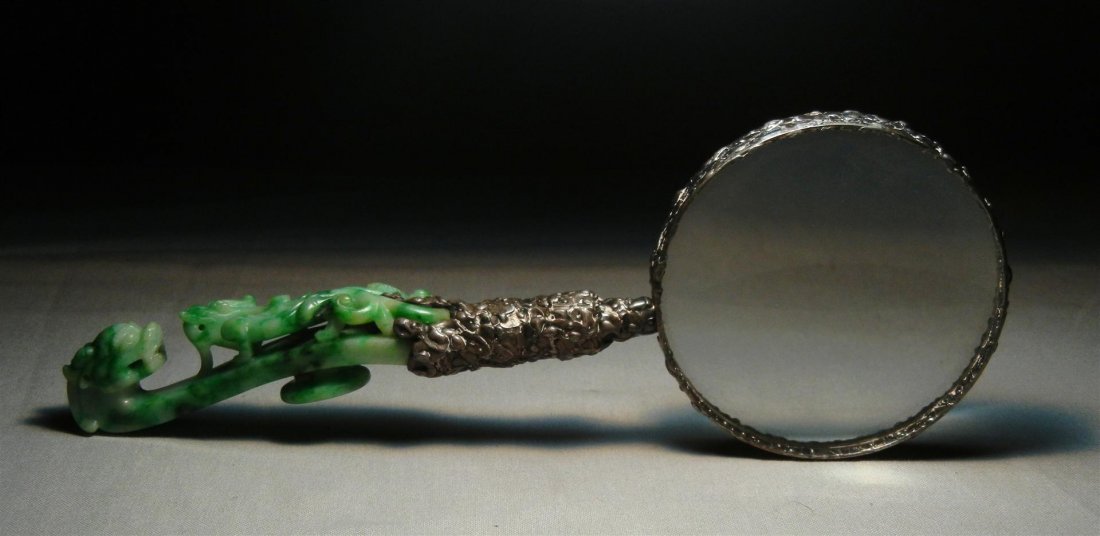 19thc. Magnifying Glass with Jade Handle: A 19th century magnifying glass with a carved green jade handle and hand wrought frame and handle mount. Magnifying glass and handle measures 8 1/2" long.