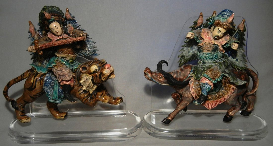 Pair of 19thc. Chinese Roof Tiles: Pair of 19th century Chinese roof tiles atop lucite stands. Figure of warrior sitting on a tiger, mounted on a lucite stand. Roof tile is polychromed in brown, green, teal and pink. It measures 12 1/2