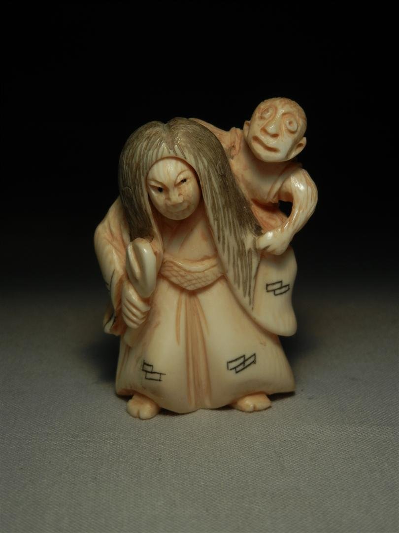19thc. Painted Ivory Netsuke: A 19th century painted ivory netsuke of a woman with a child on her back measuring 2." Woman has changeable face from old to young (shown in phtos).