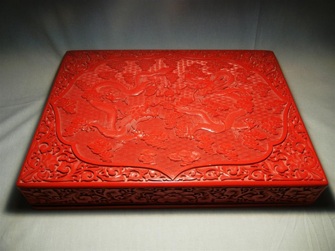 20thc. Cinnabar Covered Box: 20th century cinnabar covered box with dragon carvings and black interior. Box measures 2 1/2"H x 15" x 11."