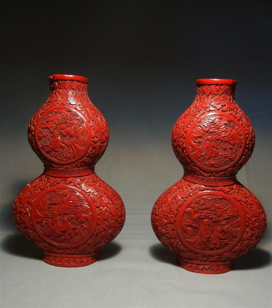 Pair of 19thc. Double Gourd Wall Pockets: Pair of 19th century cinnabar double gourd wall pockets; allover carving with figure in garden setting in cartouche. Wall pockets measure 8 1/4"H.