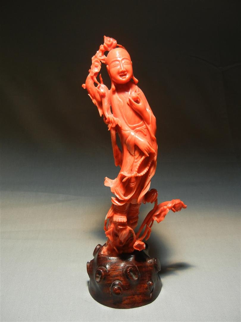 19thc. Chinese Coral Carved & Pierced Figure: 19th century Chinese coral carved and pierced standing figure of Buddhist monk on rosewood stand. Coral figure measures 7 1/2"H.