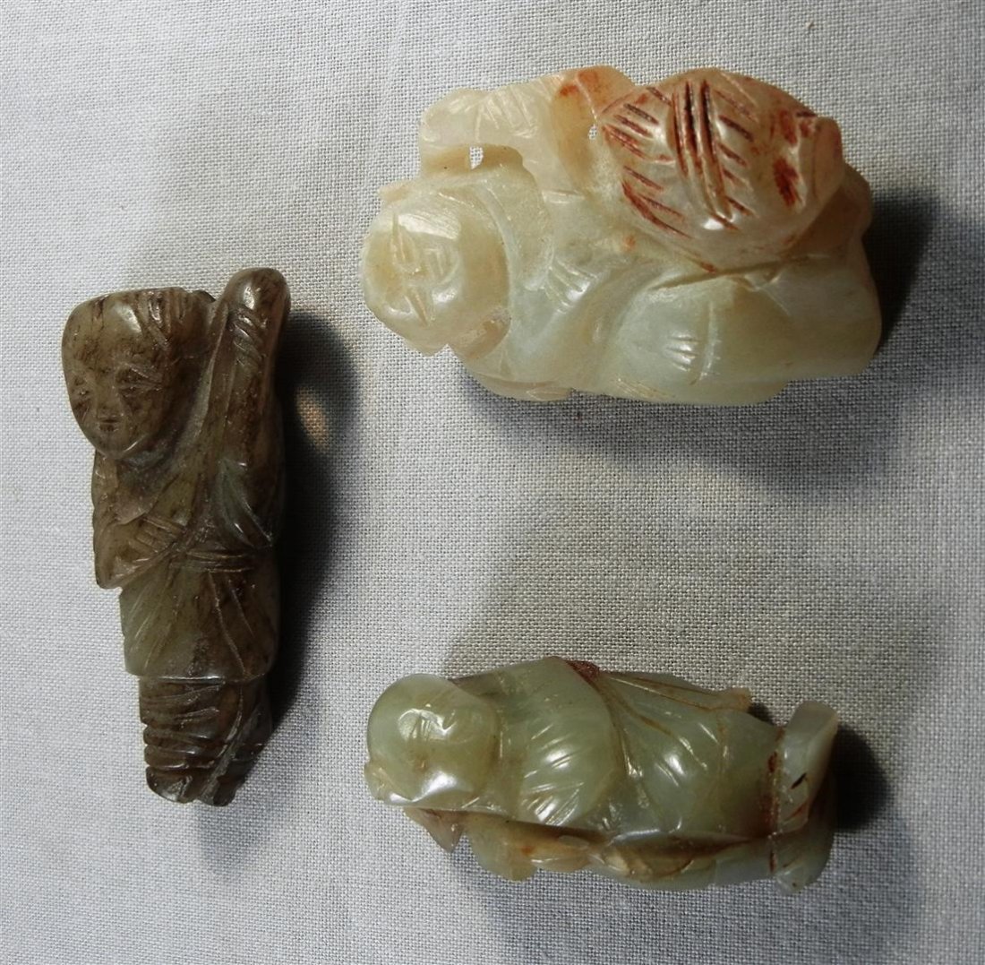 Chinese Jade Toggles: Three Chinese jade toggle ornaments depicting three men. Toggles consist of mutton, celadon and spinach jade.