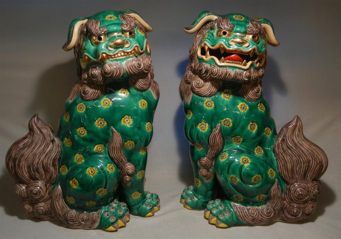 20thc. Chinese Porcelain Foo Dogs: Pair of 20th century Chinese porcelain foo dogs with emerald green glaze highlighted with brown, yellow and gilt. Foo dogs measures 21"H.