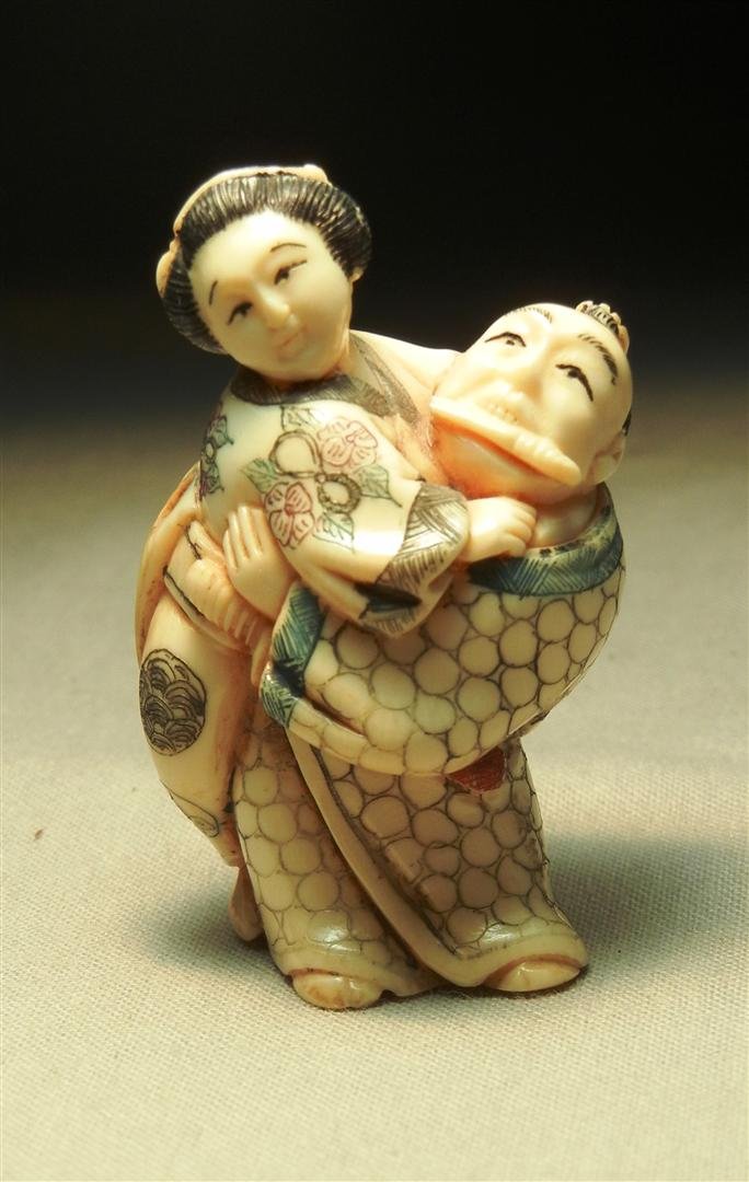 Painted Ivory Netsuke: Painted ivory netsuke of a couple embracing. Netsuke measures 2"H.
