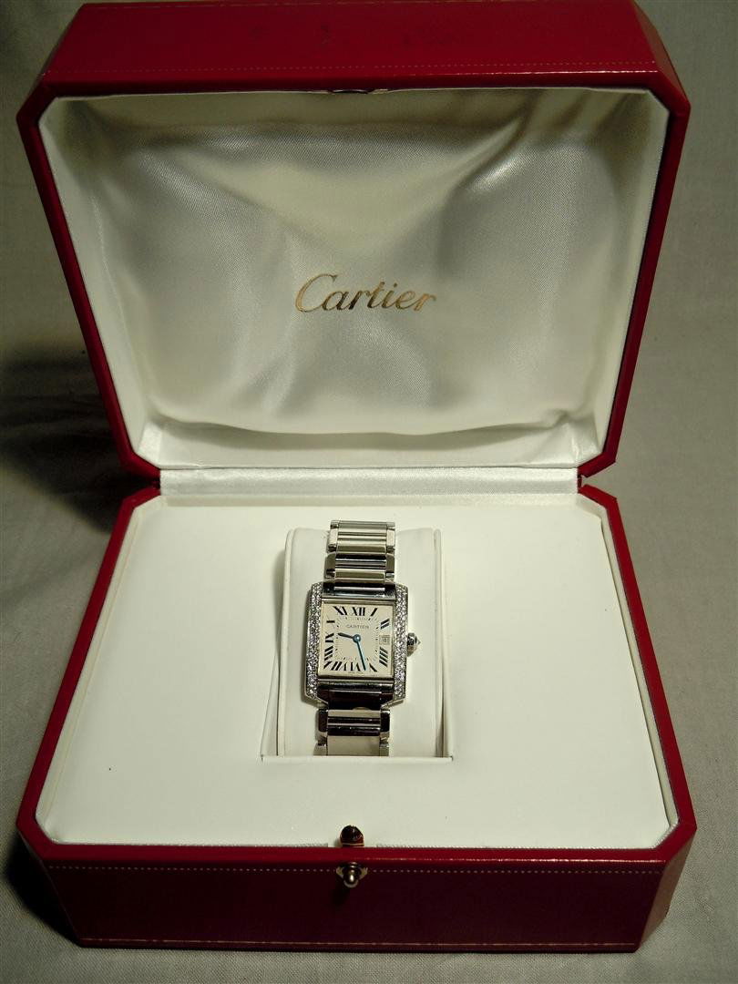 Cartier Tank Francaise Diamond Midsize Watch: Cartier Tank midsize watch with diamond bezel and diamond stem. Approximately .45 carats of diamonds. The watch comes with the original box. It is in like new condition.