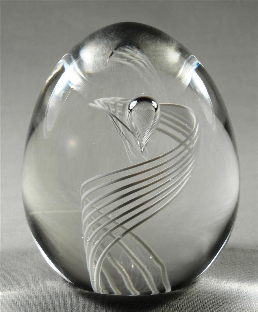 Steuben Spiral Egg Paperweight: Steuben egg shaped paper-weight with white swirl design in the inside of the paperweight. Signed Steuben on bottom (see photo). Measures 3" high x 3" diameter.