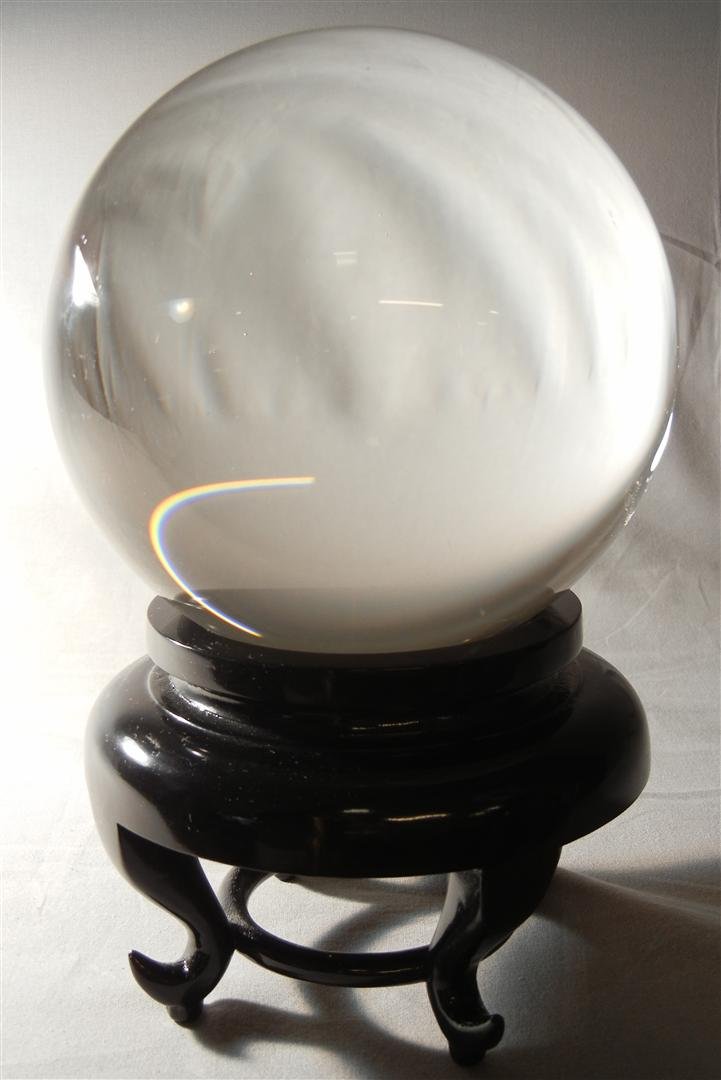 20thc. Crystal Sphere on Teak Base: 20th century crystal ball on footed teak base measuring 9"H.