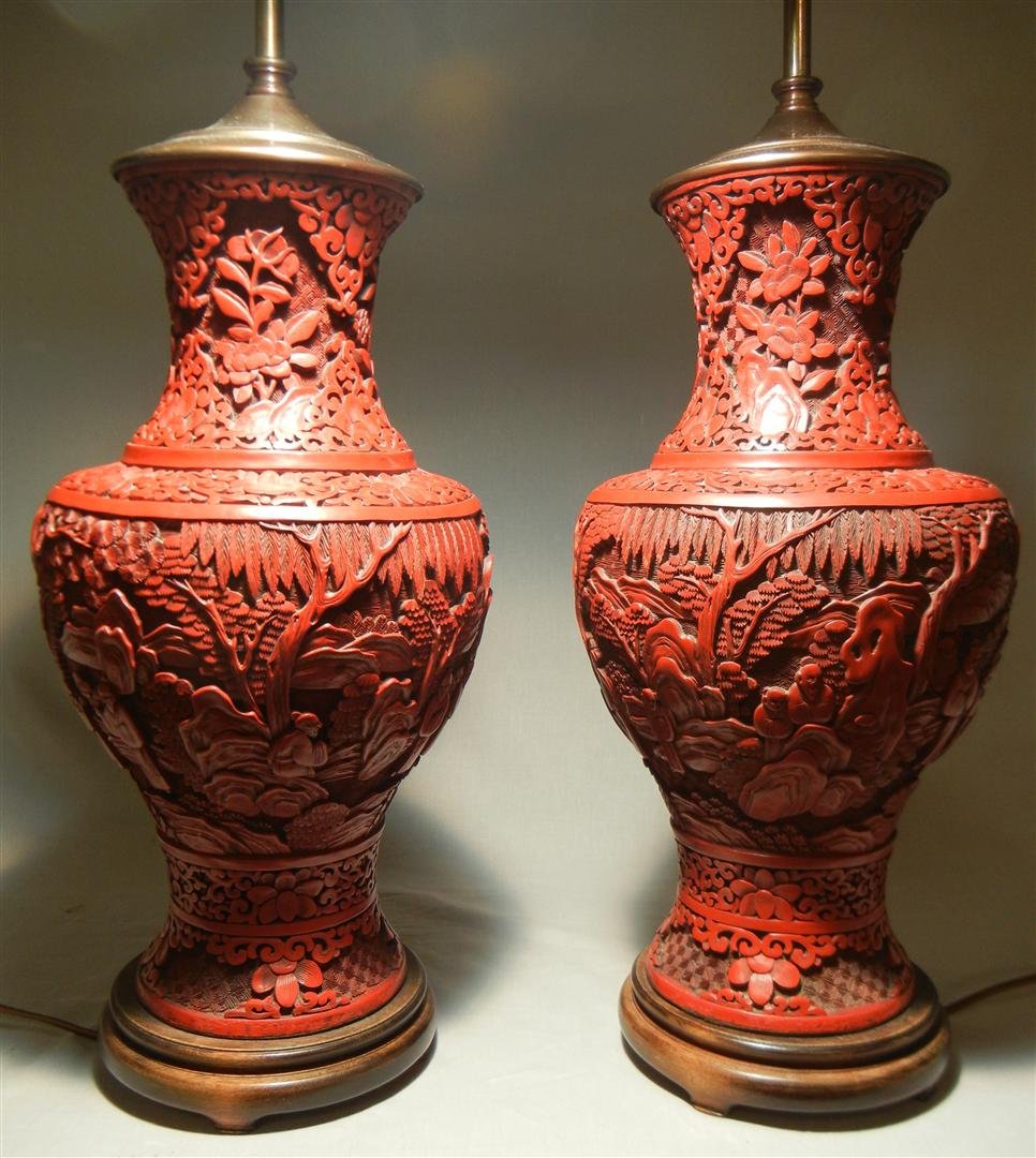 Pair of 19thc. Cinnabar Vases, now as Lamps: Pair of 19th century cinnabar vases, mounted as lamps. Lamps adorned with heavily carved landscape scenes with people and measure 16" H (vases).